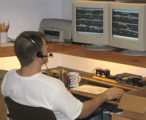 Scott Kurzawski at the APN dispatchers desk.  That CTC display on the screens is software written by Scott, and allows control of the layout thru the C/MRI interface.